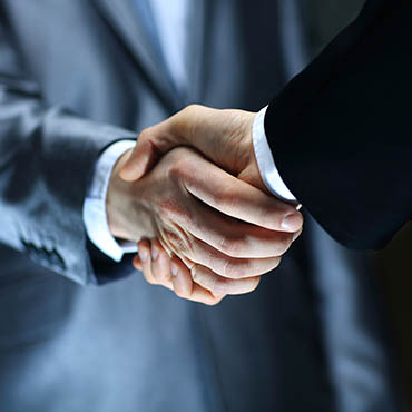 Shutterstock image: executive handshake.